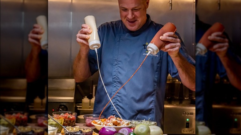 Chef sprays hot sauce on plate