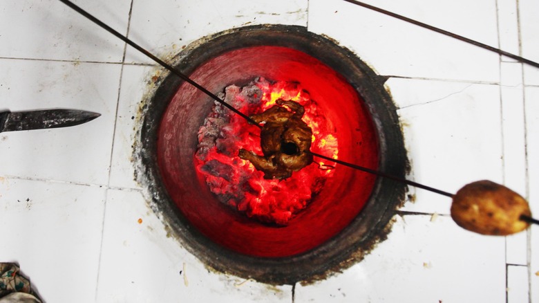 Chicken roasting in a tandoor