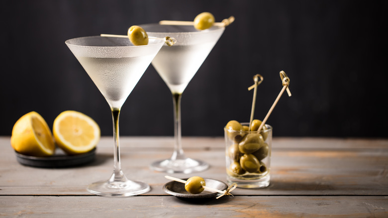 Two martinis garnished with green olives