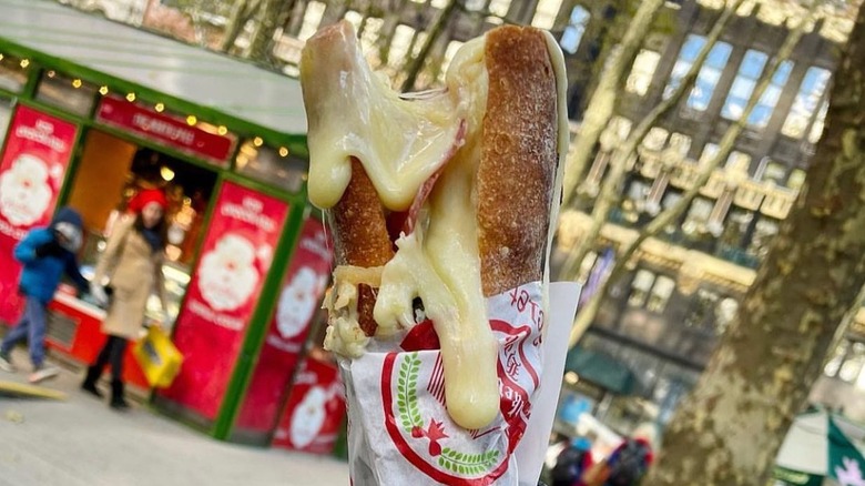 Raclette spilling down baguette