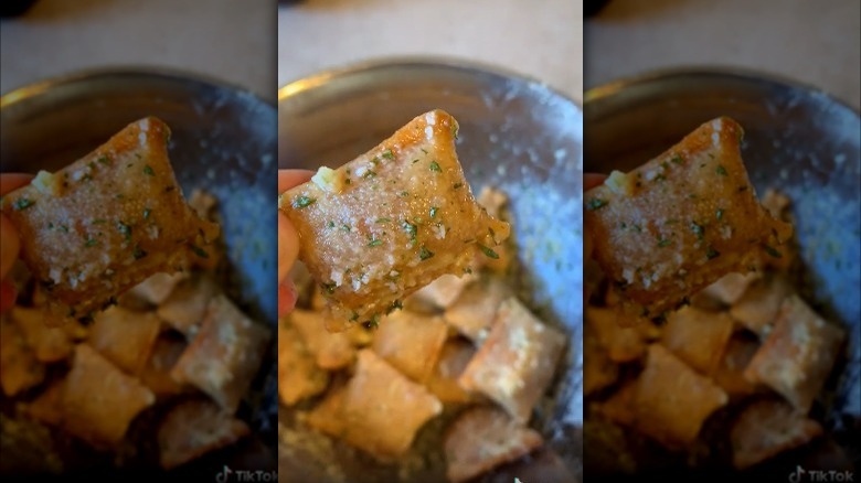 single pizza roll covered in butter and parsley