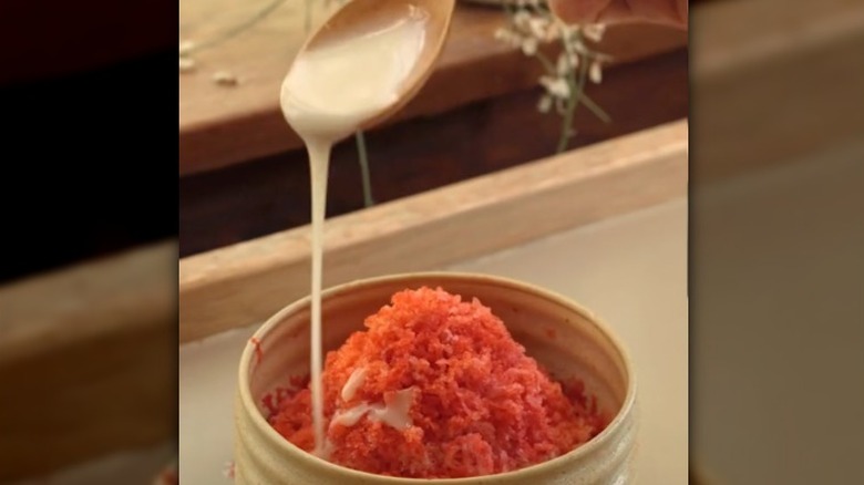 condensed milk poured onto grated frozen strawberries