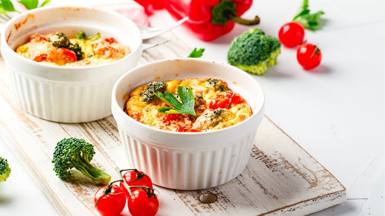 Baked eggs and vegetables in ramekins