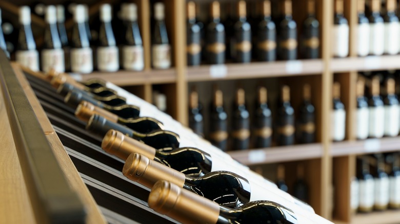 interior of a wine shop with shelves lined with bottles of wine