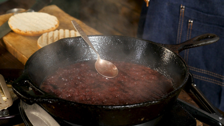 reducing a sauce in a cast iron pan