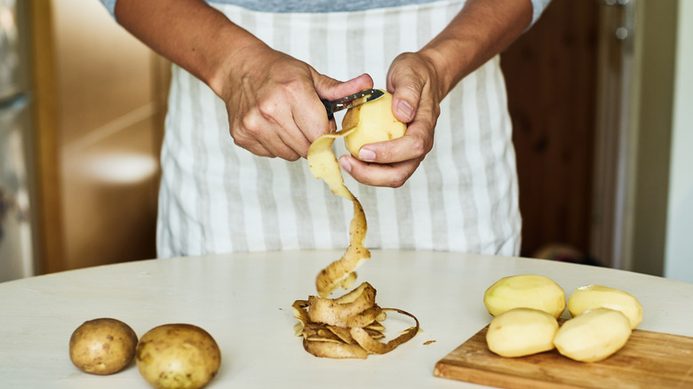 Man peeling potatoes