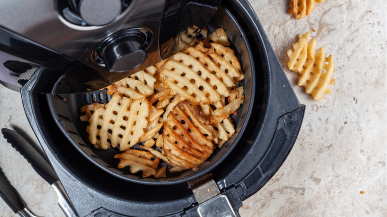 Air-fryer filled with waffle fries 