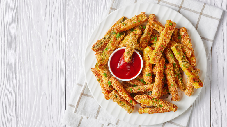 Zucchini fries with breading and ketchup