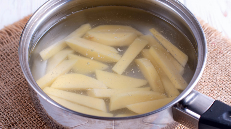 Cut potatoes in a pan of water