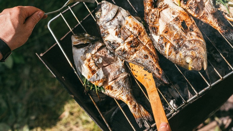 moving fish on grill with spatula