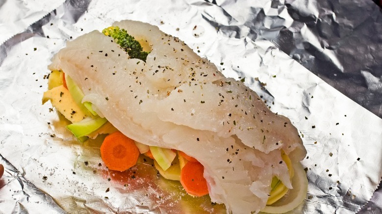 fish on top of veggies in foil