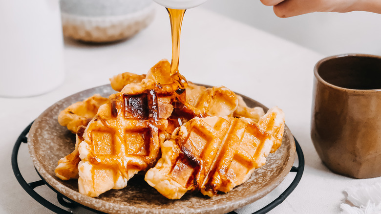 Maple syrup poured on waffles