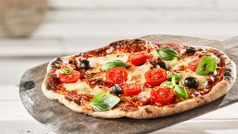 Homemade pizza on cutting board