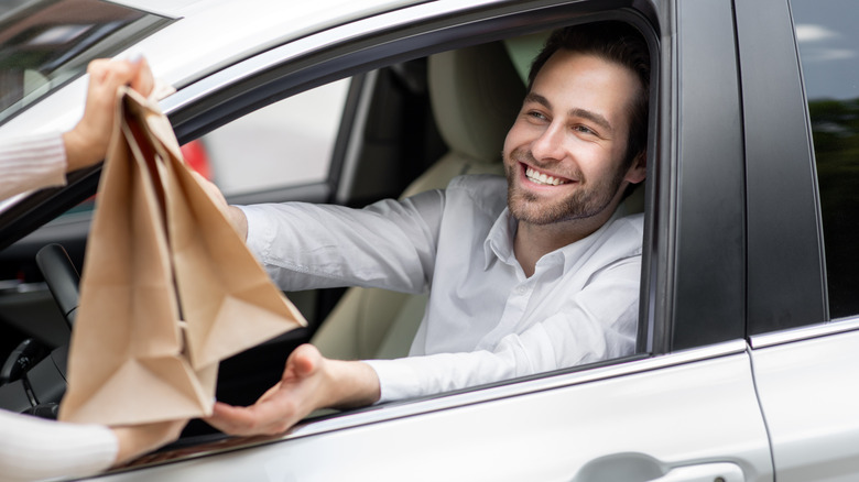 Man getting takeout order bags