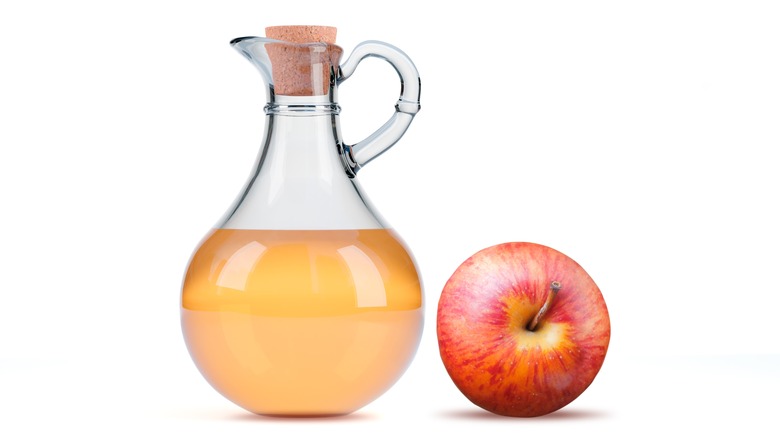 Apple cider vinegar and an apple