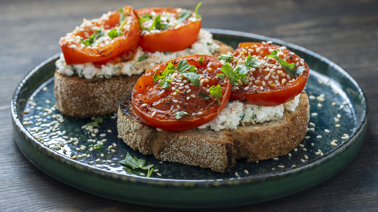 Sliced tomatoes on toasted bread