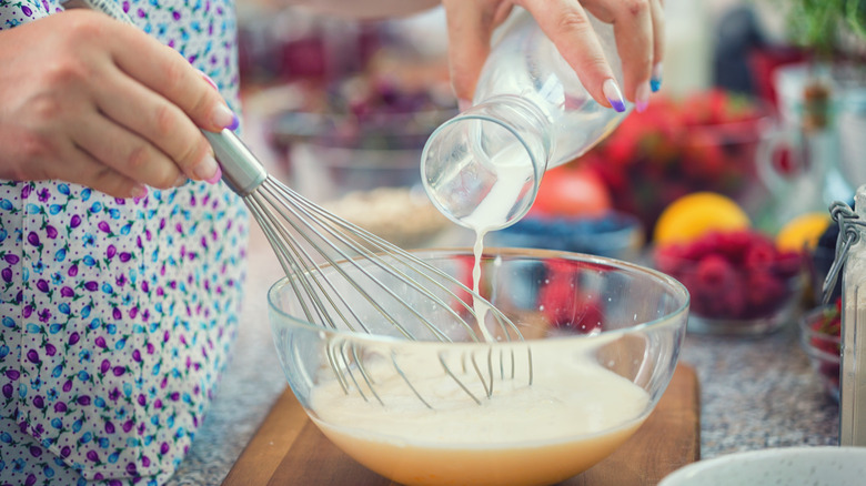 Pouring milk into batter