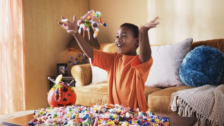 trick-or-treater with candy pile