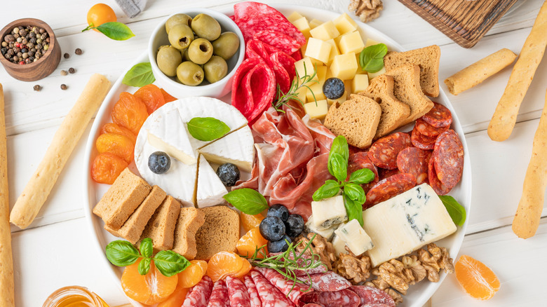 snack board with olives, meat and cheese