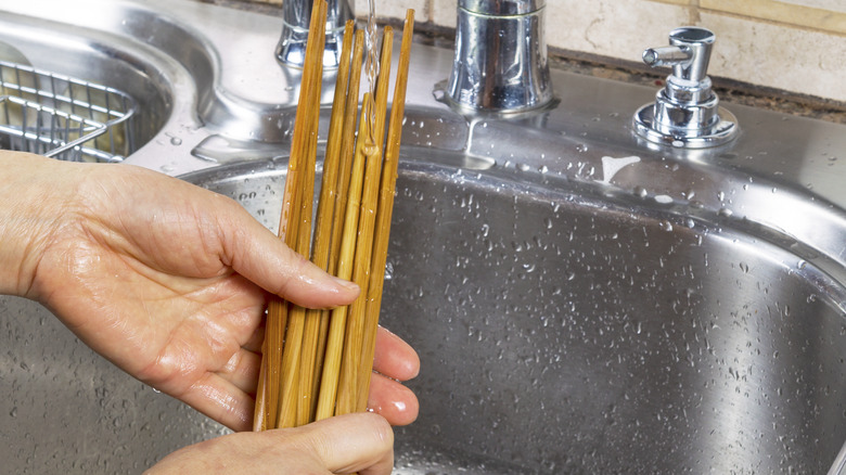 Person washing chopsticks