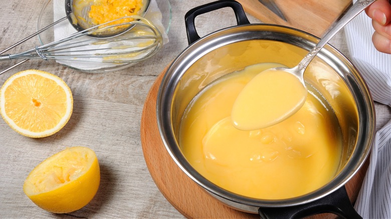 Pot of lemon curd with spoon 