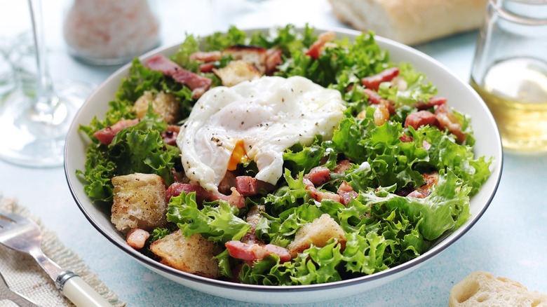 A bowl of salade lyonnaise