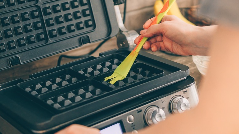 Preparing a waffle iron with brush