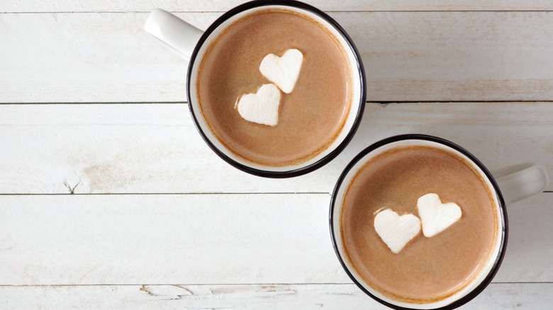 two mugs of hot chocolate with heart shaped marshmallows