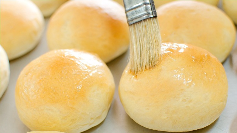 Round dinner rolls brushed with butter 