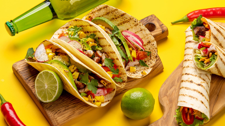 Mexican food on cutting board with beer bottle