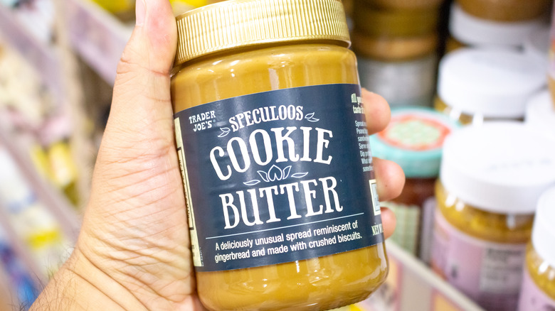Hand holding cookie butter jar