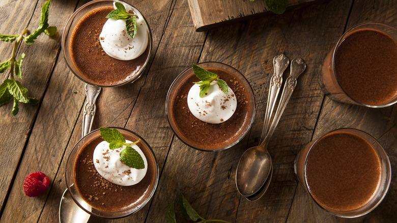 Two chocolate mousse desserts in glass cups