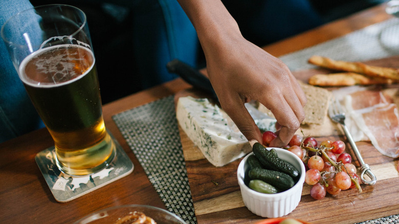 hand grabbing from snack board