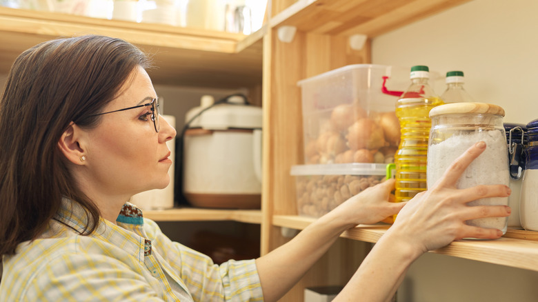 Person arranging pantry storage