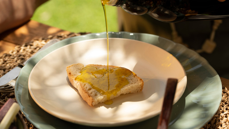 Drizzling olive oil on bread