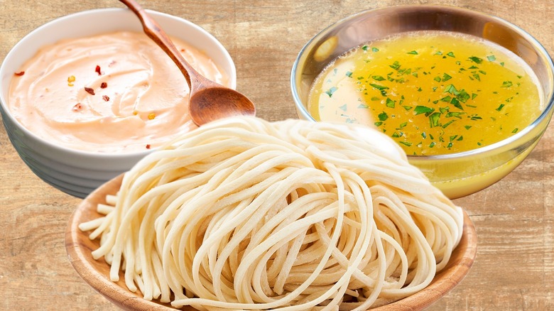 Bowls of spaghetti and salad dressing