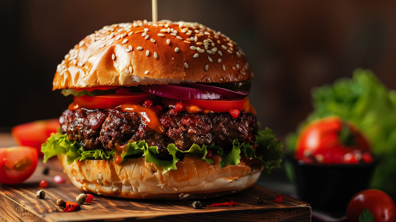 beef burger with onion, lettuce and tomato sauce