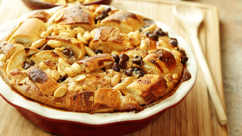 Bread pudding dessert topped with nuts and chocolate