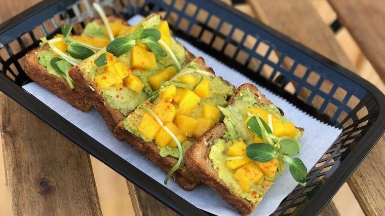 Avocado toast with mango and fresh herbs