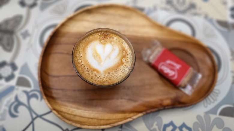 latte on tray with Biscoff cookies