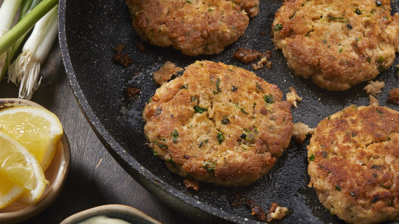 Tuna cakes cooking in a pan