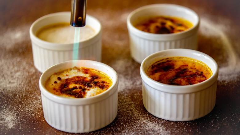 Creme brulee being crisped with a torch