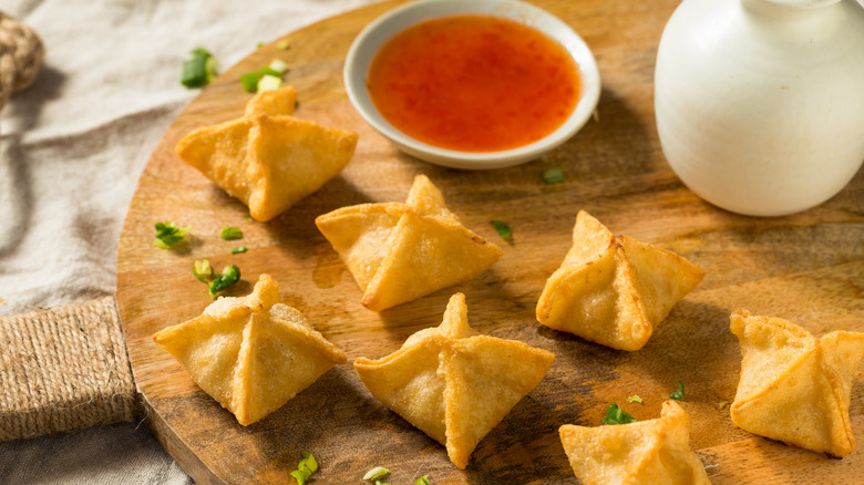 Crab rangoons on a wooden board