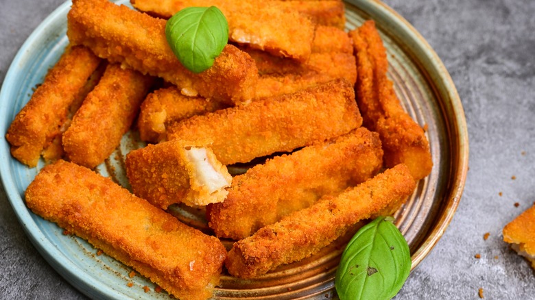 Fish sticks on a plate with basil