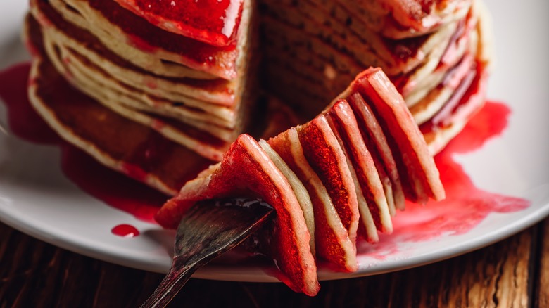 Close up of pancake stack with strawberry syrup