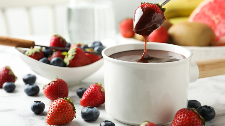 melted chocolate fondue with berries