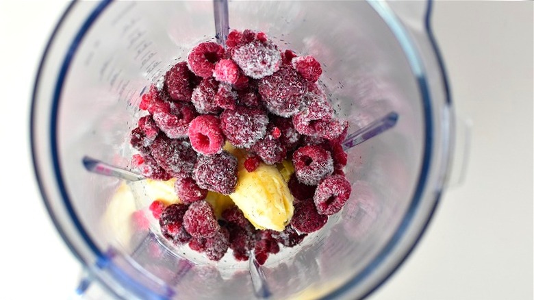 Frozen raspberries and banana in blender 