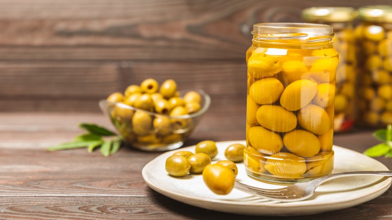 green olives jar on plate