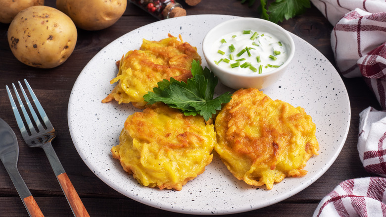 Irish boxty with sour cream on white plate