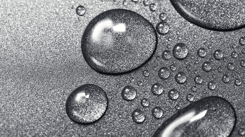 Water droplets on grey surface